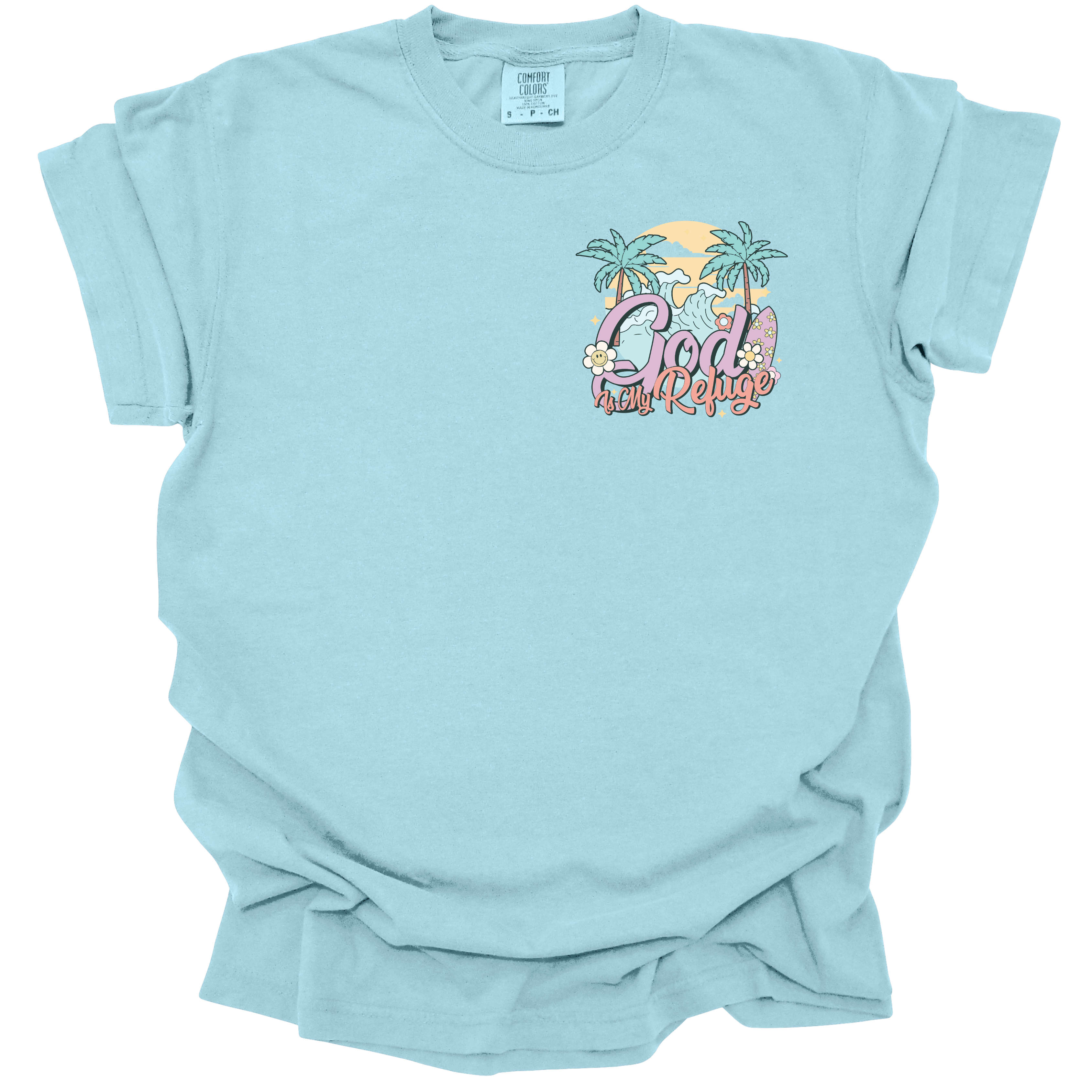 t-shirt with a small beach-themed design featuring the text "God Is My Refuge" with palm trees, waves, and pastel accents.