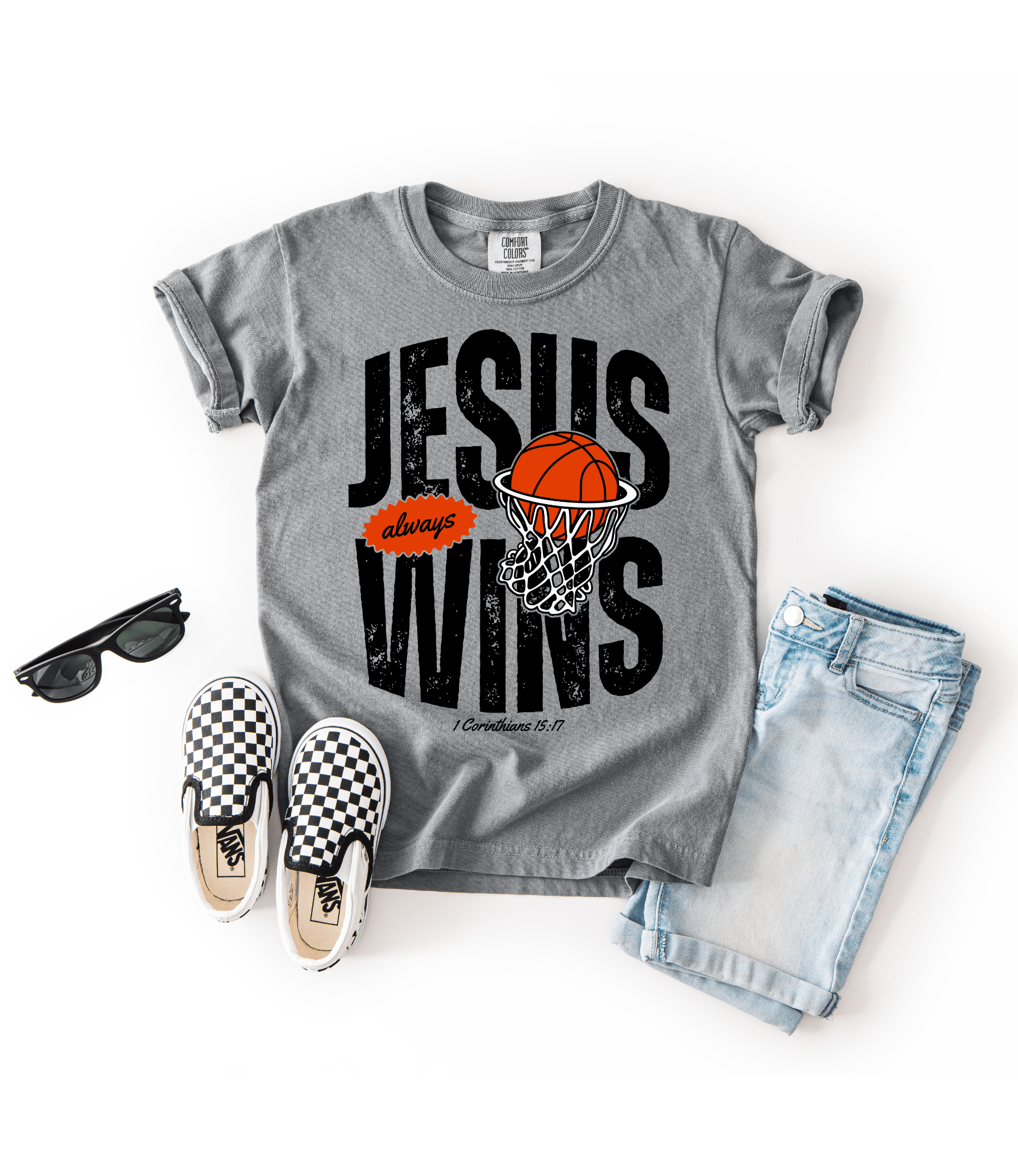 Gray t-shirt with 'Jesus always wins' design, sunglasses, checkered shoes, and jeans on a white background