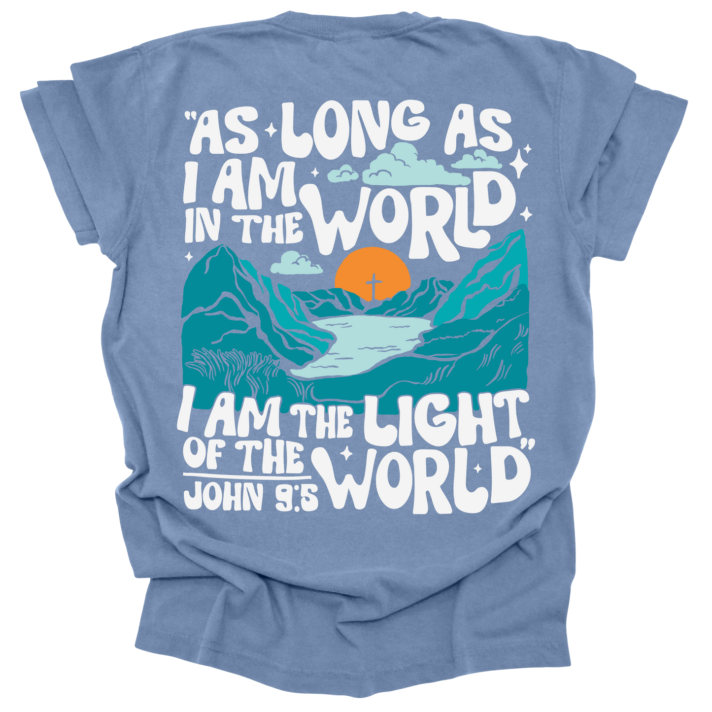 Washed Denim t-shirt featuring a bold mountain and sunrise design with the words "As long as I am in the world, I am the light of the world" from John 9:5.