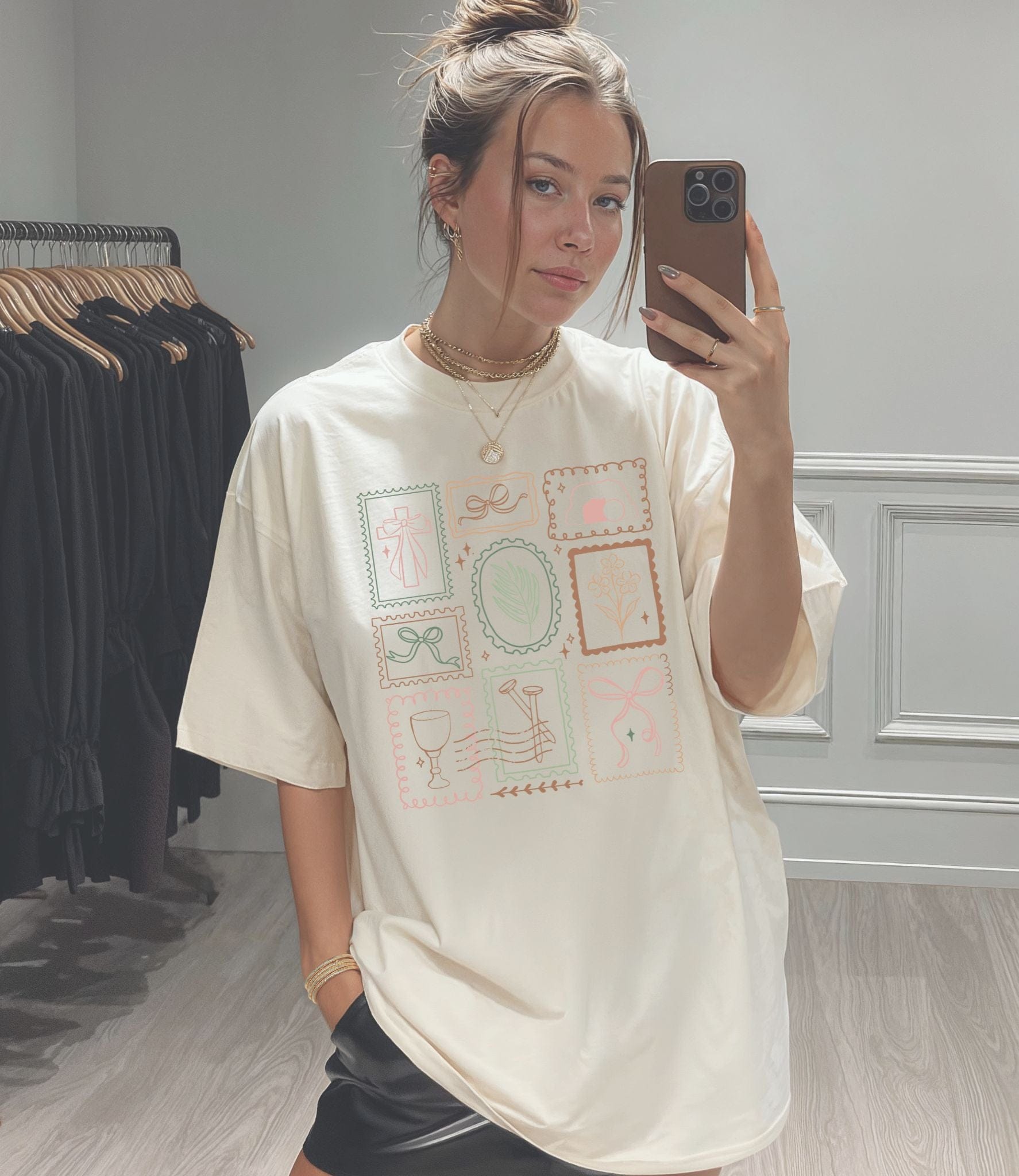 Adult unisex tee from MADE BY YEN featuring a colorful Easter stamp design on a model.