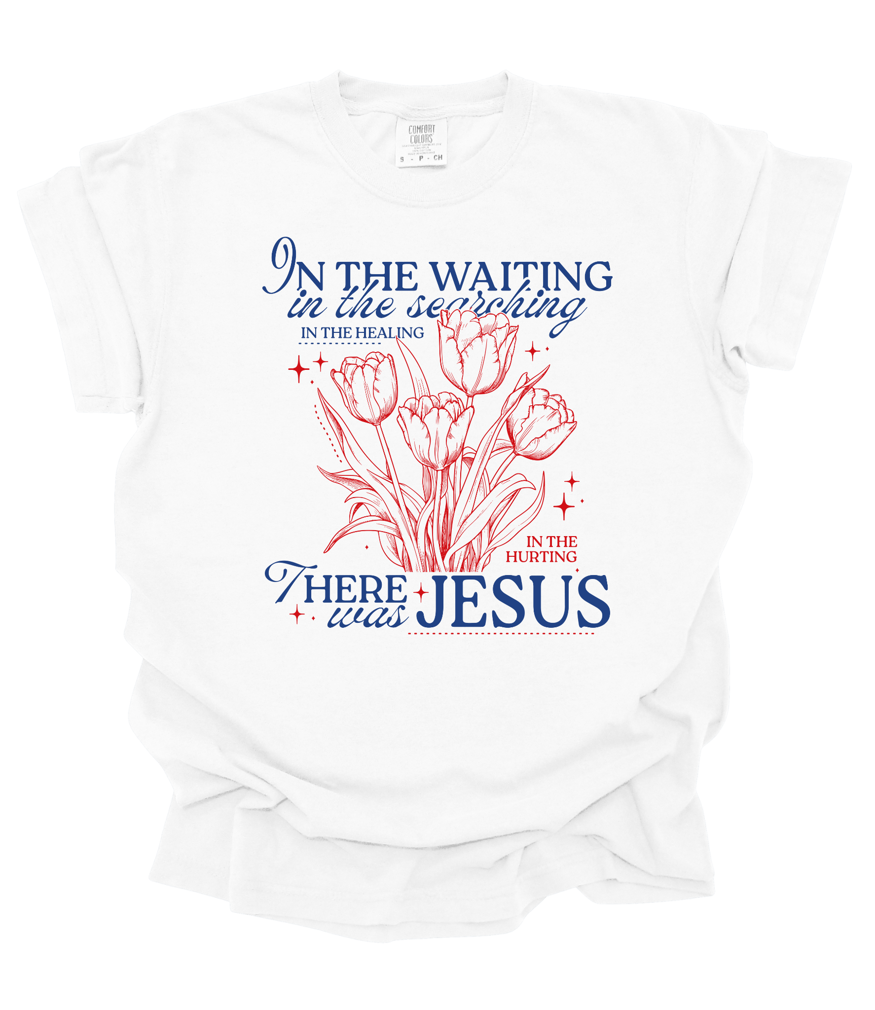 White t-shirt featuring red tulip drawing and blue/red text that reads: “In the waiting… there was Jesus.” Inspirational Christian floral shirt.
Let me know if you want a version for a caption or email campaign!