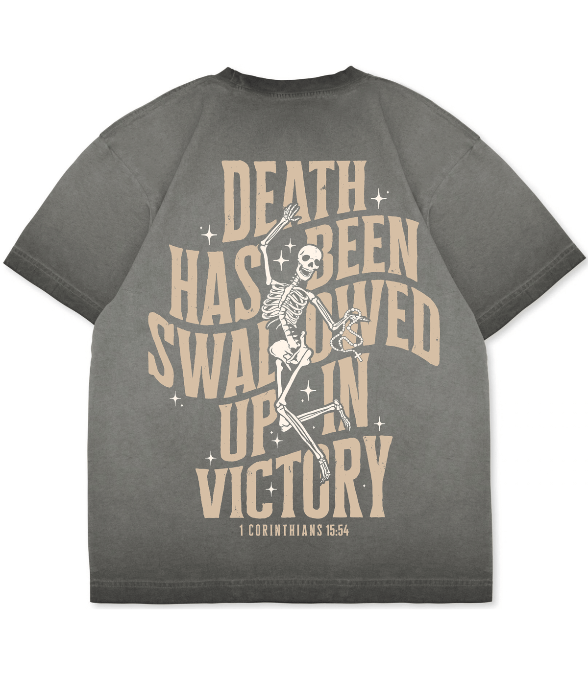 A dark gray t-shirt featuring a large graphic print on the back. The design displays a dancing skeleton in the center, surrounded by arched beige text that reads 'DEATH HAS BEEN SWAILED UP IN VICTORY' with small star accents, and '1 CORINTHIANS 15:54' printed below in a straight serif font.