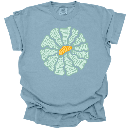 Ice Blue t-shirt with a circular, retro-inspired design featuring the attributes of God, including Faithful, Merciful, Eternal, Good, Infinite, In Control, and More, with the text "God Is" in vibrant orange at the center.