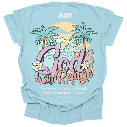 t-shirt featuring a large tropical scene with palm trees, waves, and surfboards, along with the words "God Is My Refuge" and the verse Psalm 46.