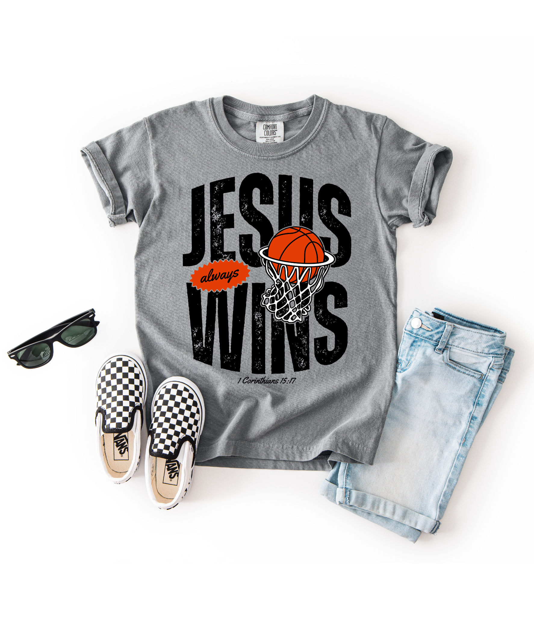 Gray t-shirt with 'Jesus always wins' design, sunglasses, checkered shoes, and jeans on a white background