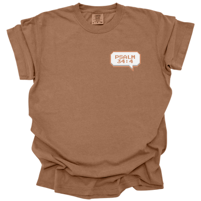 Brown-colored t-shirt with a small 8-bit speech bubble that reads "Psalm 34:4" in retro pixel font.
