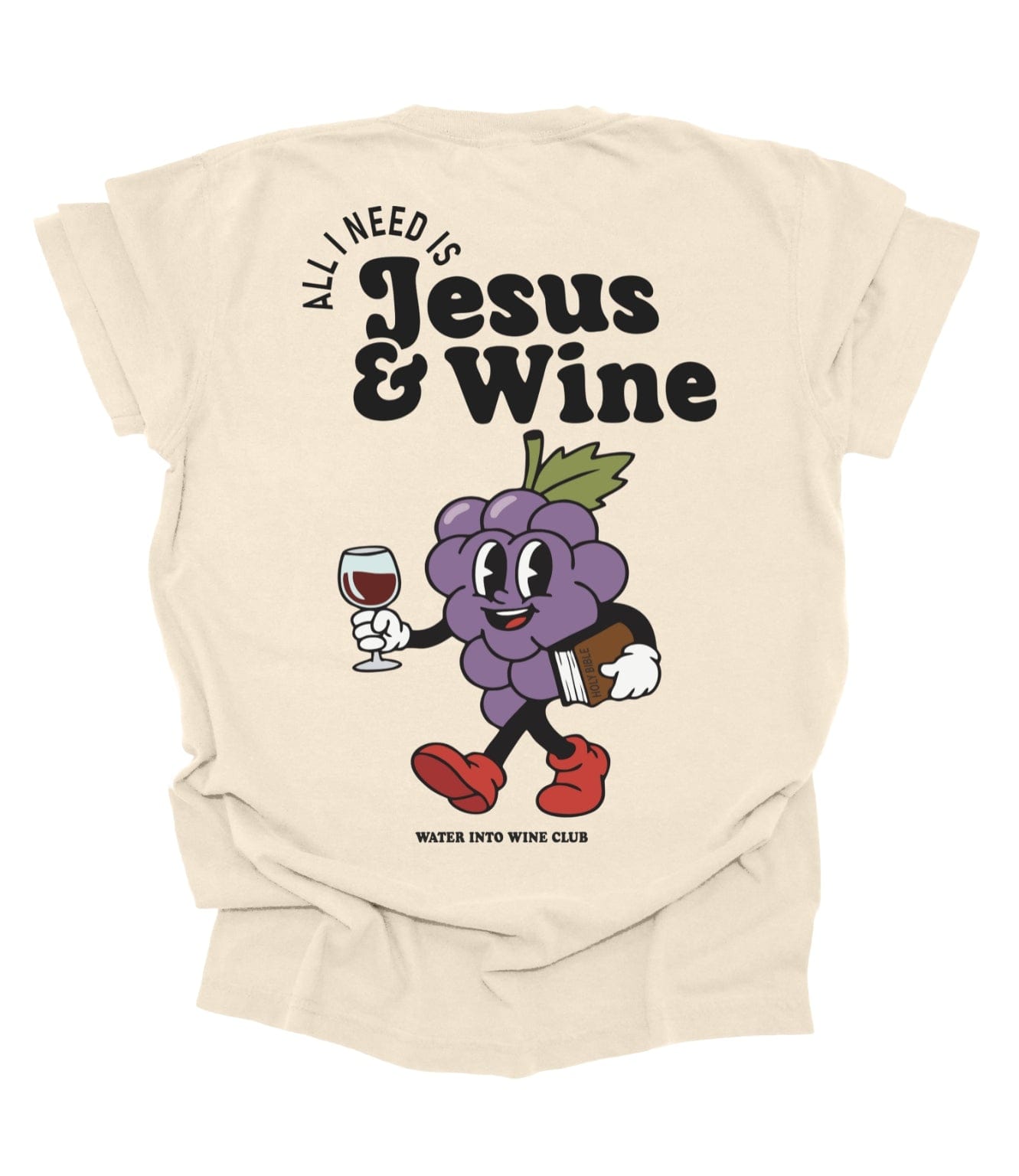 Back of ivory tee with vintage grape character holding wine and Bible and the phrase “All I Need Is Jesus & Wine.”