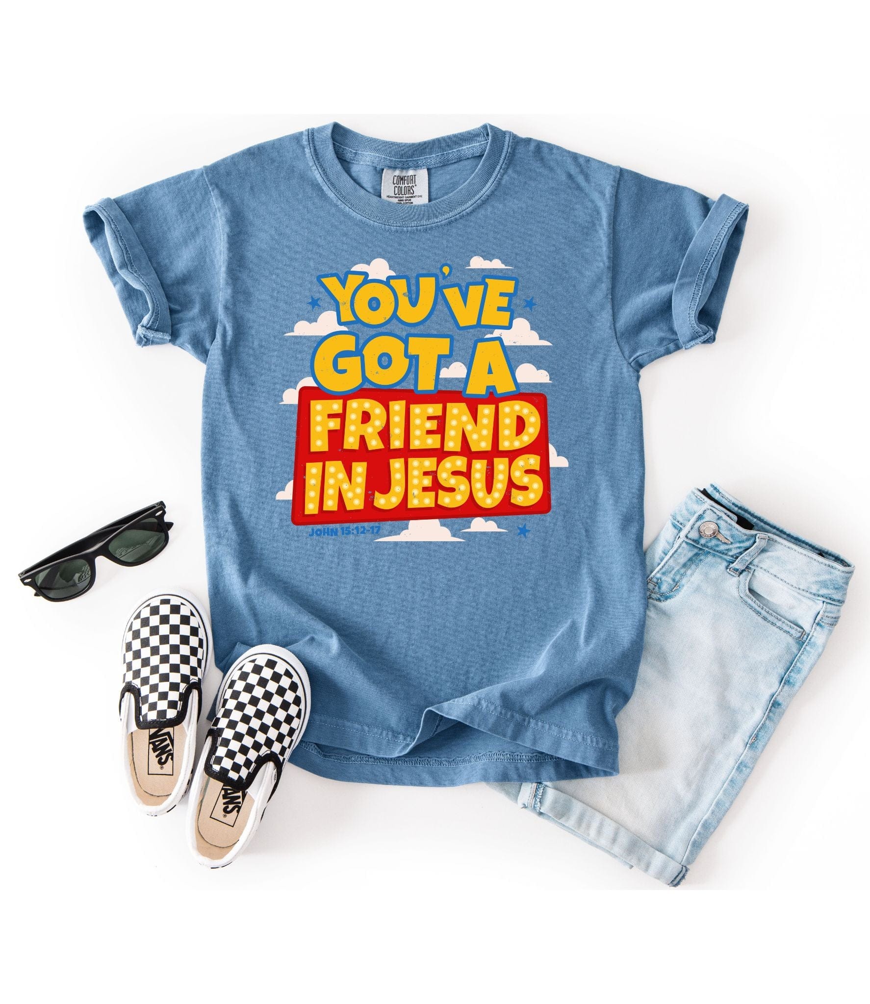 Blue t-shirt with 'You've Got a Friend in Jesus' text, sunglasses, checkered shoes, and denim shorts on a white background