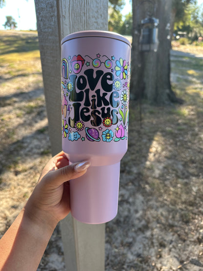 video of Love Like Jesus 40 oz tumbler with inspirational faith-based design, perfect for staying hydrated while spreading the message of Christ's love. Durable, stainless steel tumbler with double-wall insulation for hot and cold beverages, ideal for Christians, prayer groups, and faith-inspired gifting. Shop Made by Yen for handmade, faith-focused accessories.