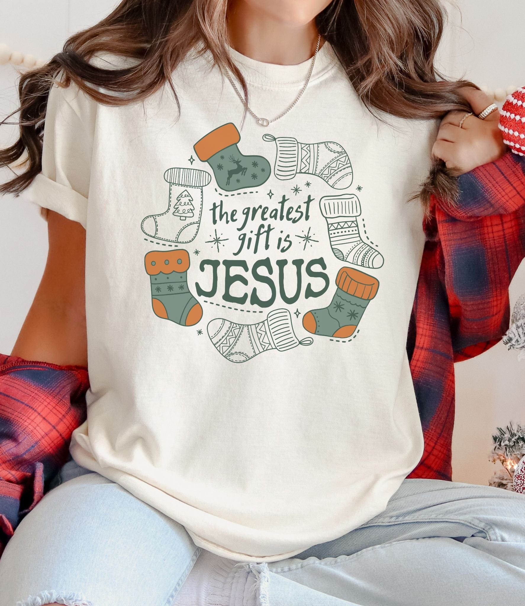 Person wearing a white t-shirt with Christmas-themed design and text.